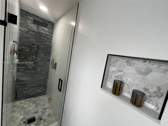 bathroom with a shower with door