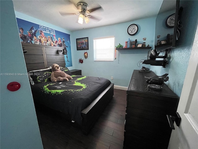 bedroom with dark hardwood / wood-style flooring and ceiling fan