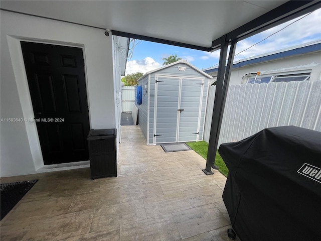 view of patio featuring grilling area and a shed