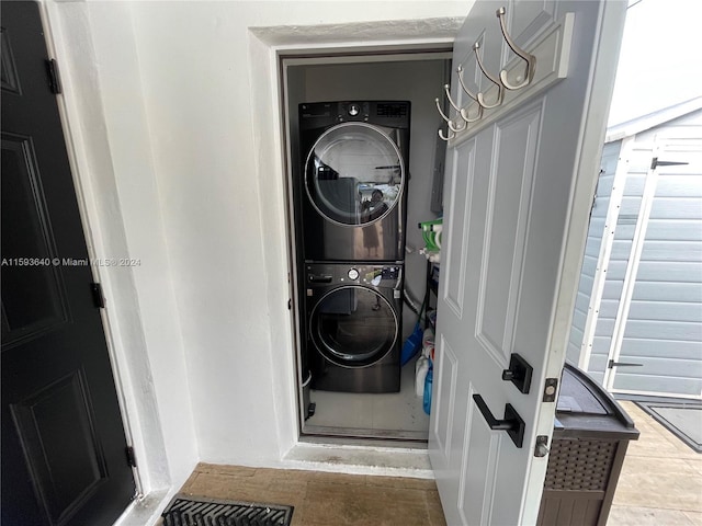 laundry area featuring stacked washer and dryer