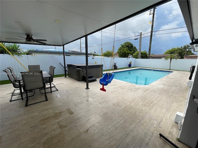 view of swimming pool featuring a hot tub and a patio area