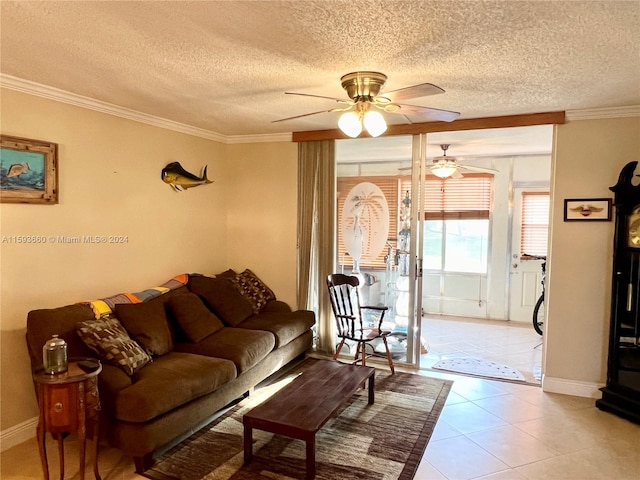 tiled living room featuring a textured ceiling, ornamental molding, and ceiling fan