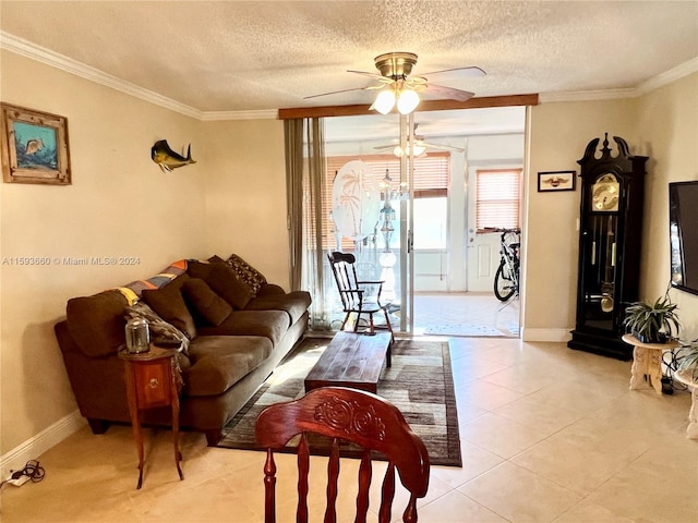 living room featuring ceiling fan, light tile flooring, a textured ceiling, and crown molding