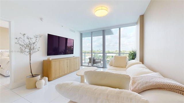 tiled living room with expansive windows and a healthy amount of sunlight