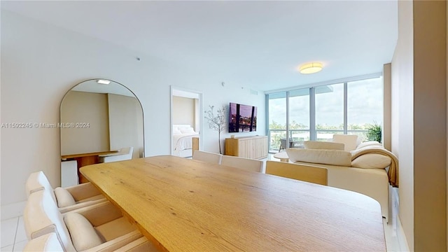 dining space with expansive windows and light tile patterned floors