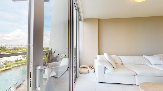 tiled living room featuring a water view