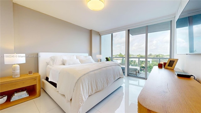 tiled bedroom featuring access to outside and floor to ceiling windows