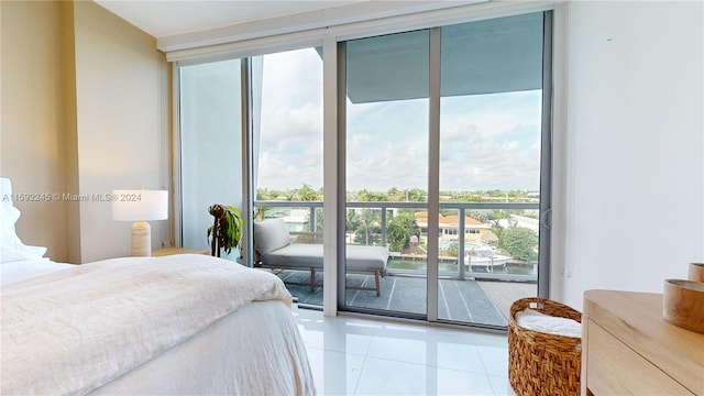 tiled bedroom featuring expansive windows and access to exterior