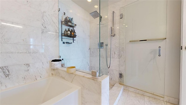 bathroom featuring shower with separate bathtub