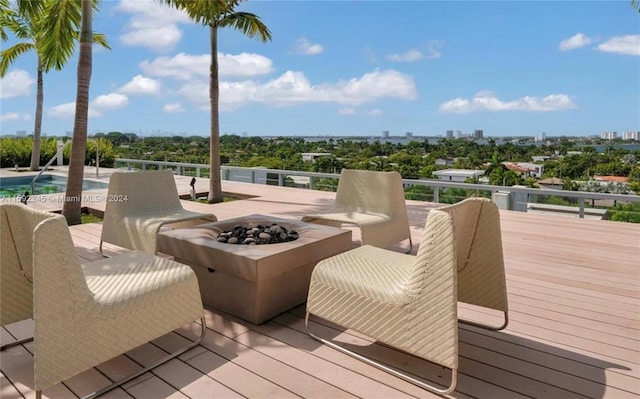 wooden terrace featuring a fire pit