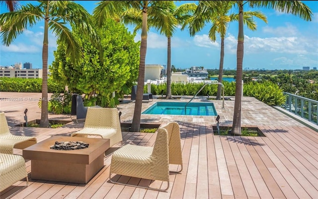 view of swimming pool featuring a patio and an outdoor fire pit