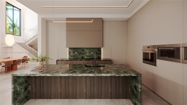 kitchen with sink, oven, and dark stone counters