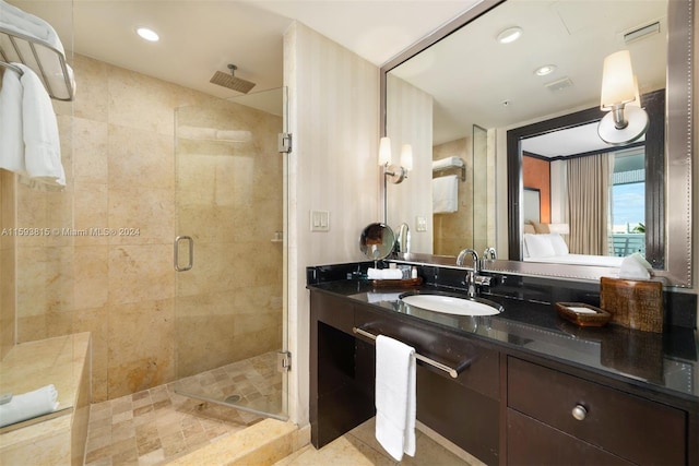 bathroom featuring an enclosed shower and vanity