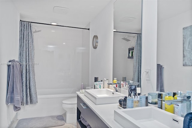 full bathroom featuring dual sinks, toilet, tile flooring, large vanity, and shower / tub combo with curtain