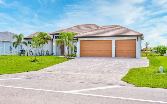 view of front facade with a garage and a front lawn