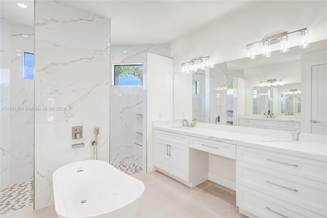 bathroom featuring vanity and independent shower and bath