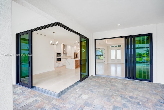 interior space featuring an inviting chandelier and french doors