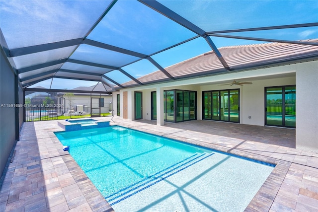 view of pool featuring an in ground hot tub, ceiling fan, glass enclosure, and a patio