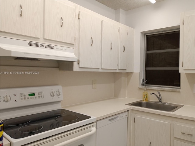 5387 SW 40th Ave Unit 105, Dania Beach, FL 33314 - kitchen featuring white appliances, under cabinet range hood, a sink, light countertops, and a textured ceiling