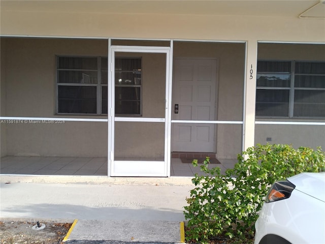 5387 SW 40th Ave Unit 105, Dania Beach, FL 33314 - doorway to property featuring stucco siding