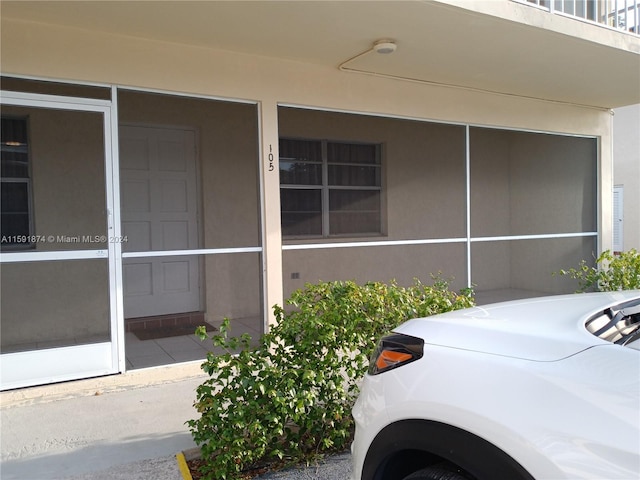5387 SW 40th Ave Unit 105, Dania Beach, FL 33314 - doorway to property with washer / clothes dryer and stucco siding