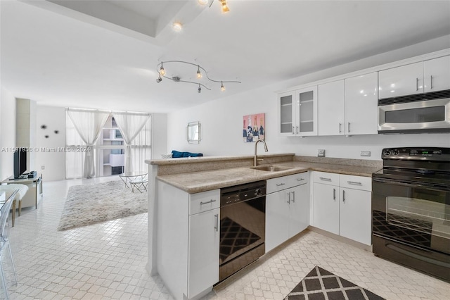 kitchen featuring kitchen peninsula, black appliances, light tile floors, sink, and white cabinetry