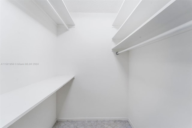 walk in closet featuring tile floors