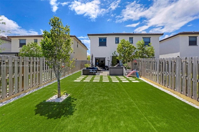 rear view of property featuring an outdoor living space, a yard, and a patio