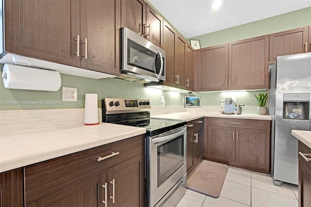 kitchen with stainless steel appliances and light tile patterned flooring