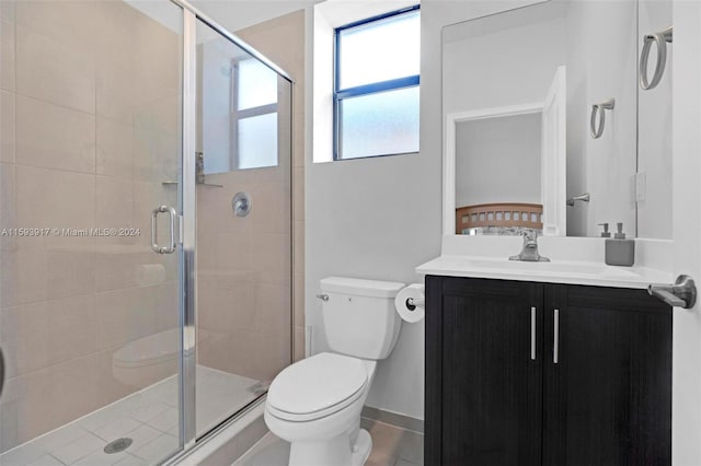 bathroom with tile patterned floors, vanity, toilet, and an enclosed shower