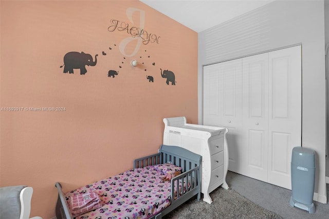 carpeted bedroom featuring a closet and a nursery area