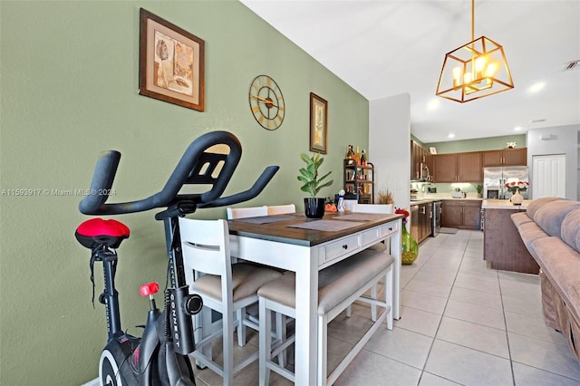 dining space featuring a notable chandelier and light tile patterned floors