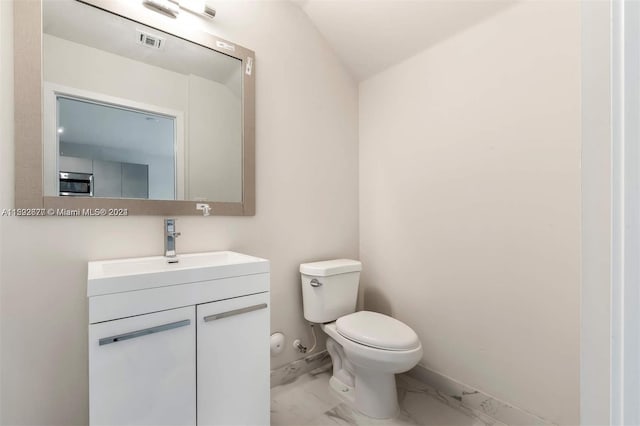 bathroom featuring tile flooring, oversized vanity, and toilet