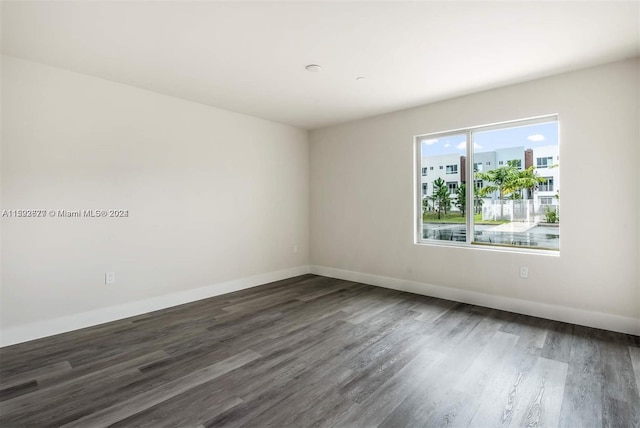 spare room featuring dark hardwood / wood-style floors