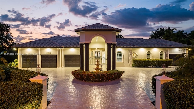 mediterranean / spanish-style home featuring a garage