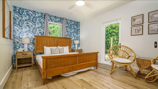 bedroom featuring multiple windows, ceiling fan, and light wood-type flooring