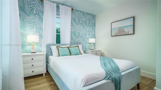 bedroom featuring light hardwood / wood-style floors and multiple windows