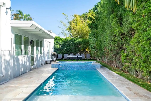 view of swimming pool with a patio area