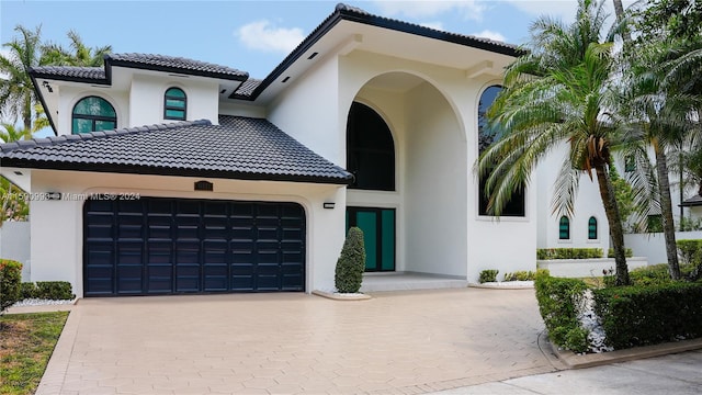 mediterranean / spanish-style home with a garage