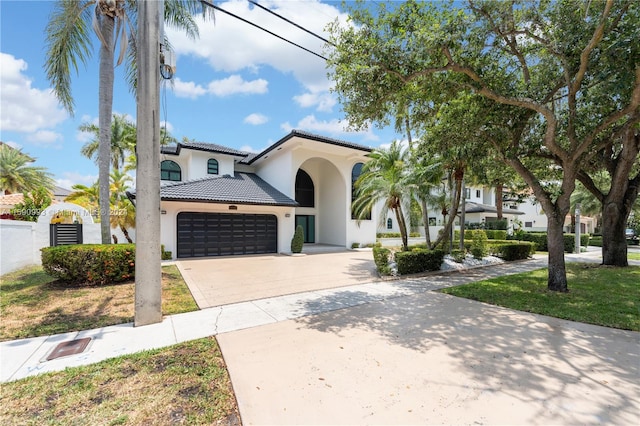 mediterranean / spanish-style home featuring a garage