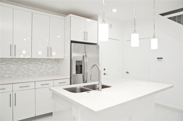 kitchen featuring decorative light fixtures, white cabinetry, sink, and stainless steel fridge with ice dispenser