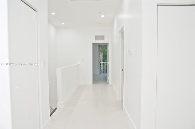 hallway with light tile patterned floors