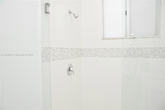 bathroom with tile walls and a tile shower