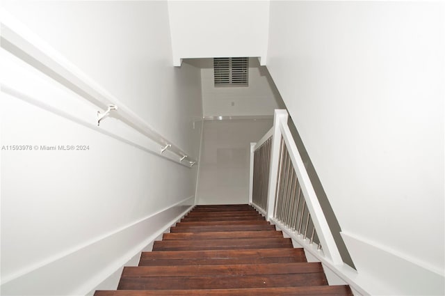 staircase with wood-type flooring