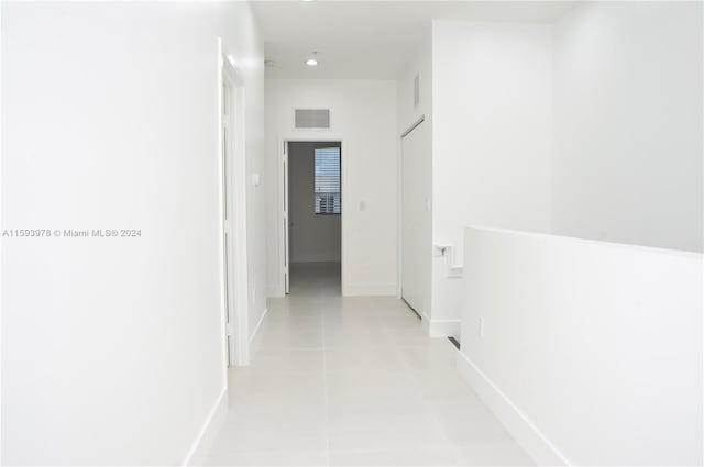 hallway featuring light tile patterned floors