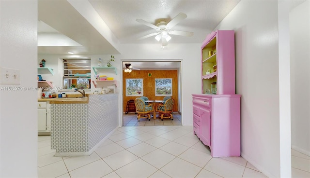 interior space with ceiling fan