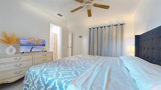 tiled bedroom with ceiling fan