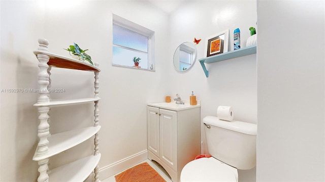 bathroom with toilet and vanity