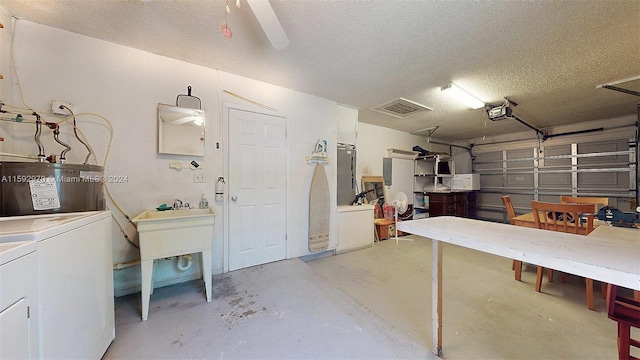 garage featuring ceiling fan, washer and clothes dryer, and a garage door opener