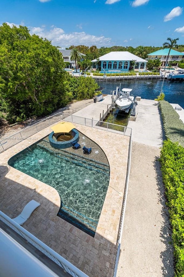 view of pool with a boat dock and an in ground hot tub